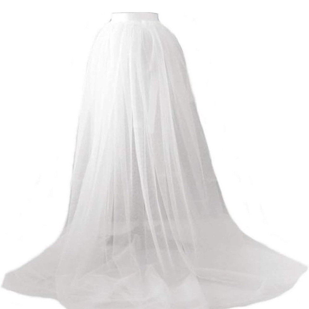 Women’s long tulle white skirt. Brand new; never worn. Ties so adjustable.